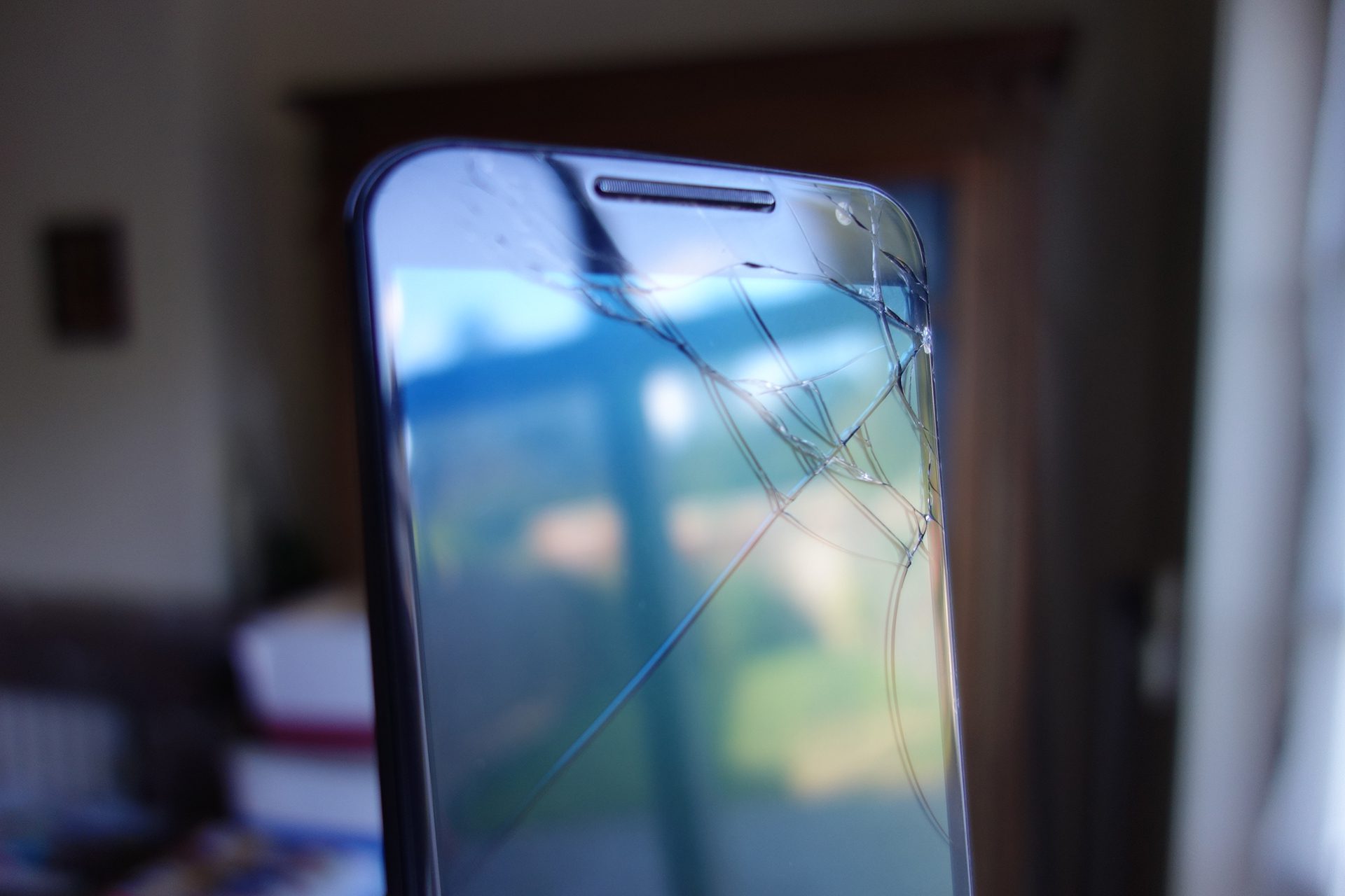 Màn hình smartphone bị vỡ kính trên bàn làm việc