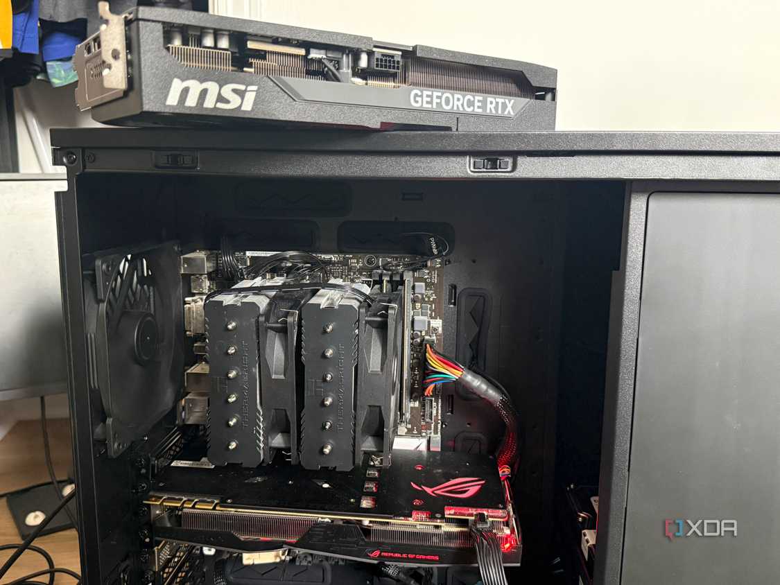 A photo of a home lab PC build with a GPU sitting on top of the chassis
