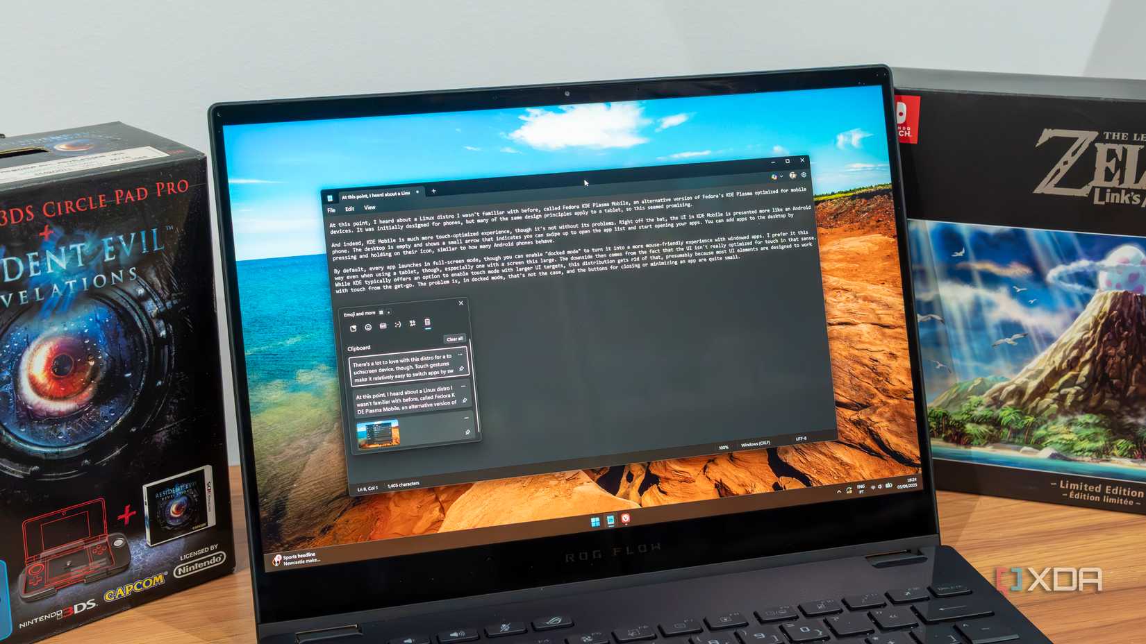 A Windows 11 laptop with the clipboard history flyout open over the Notepad