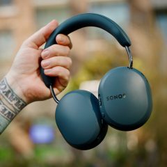 Blue Agave Sonos Ace Ultra headphones being held outdoors