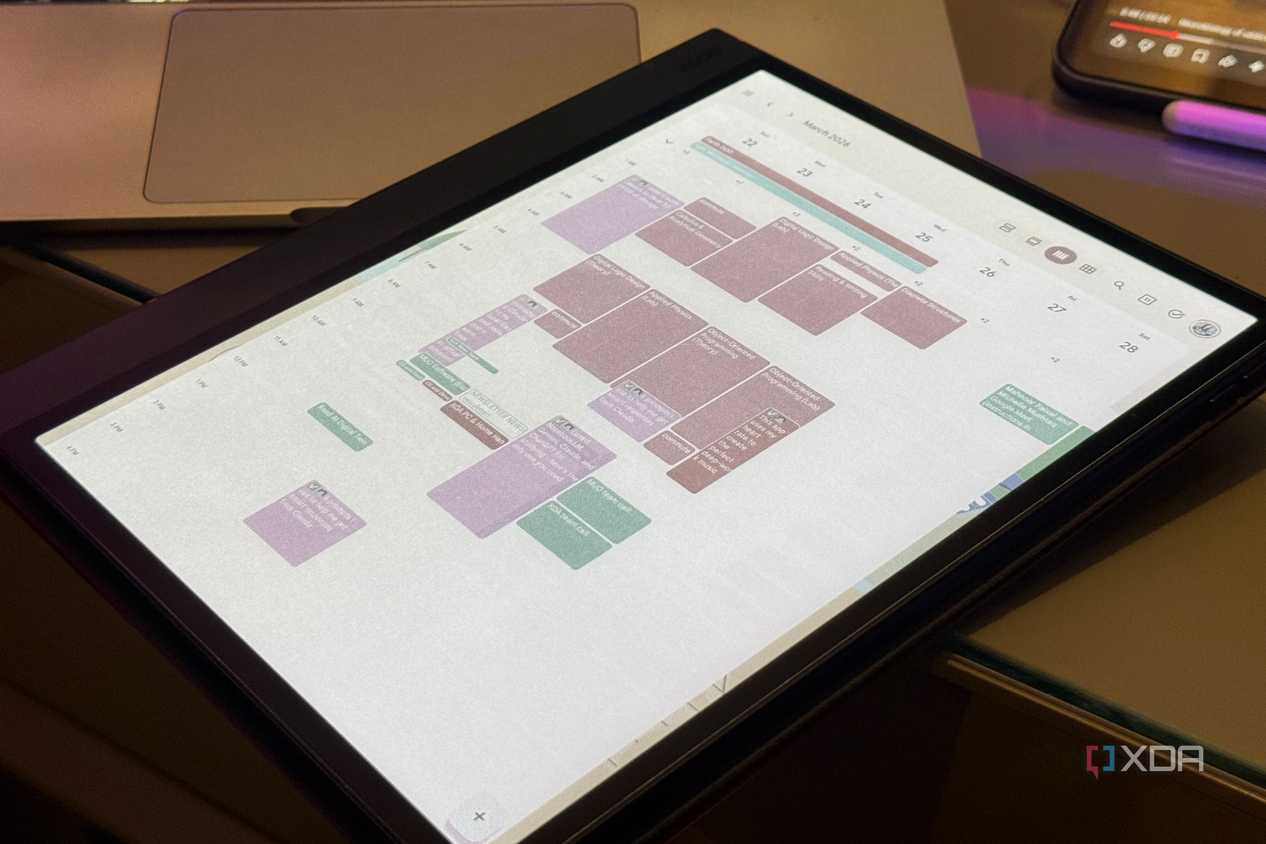 Boox color E Ink tablet showing a March week in Google Calendar beside a laptop and phone
