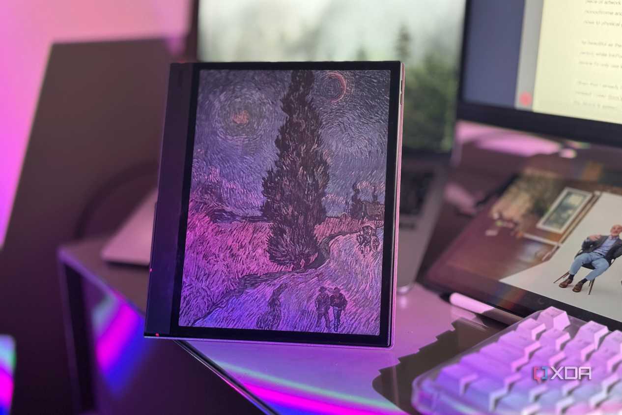 Boox tablet's color screen showing a Van Gogh painting, with an iPad playing a video behind