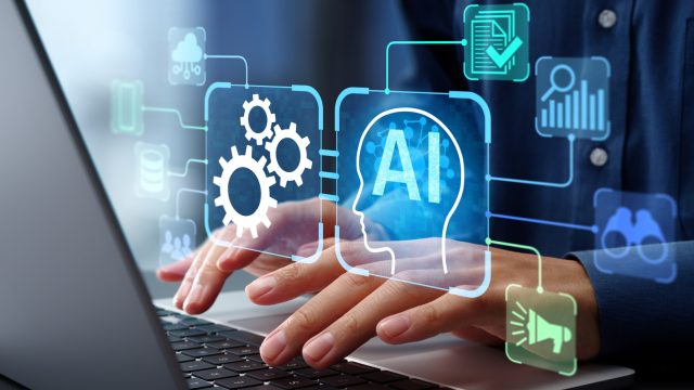 Đồ họa AI ghép trên hình người gõ bàn phím laptop.