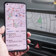 Google Maps on a phone in front of Android Auto