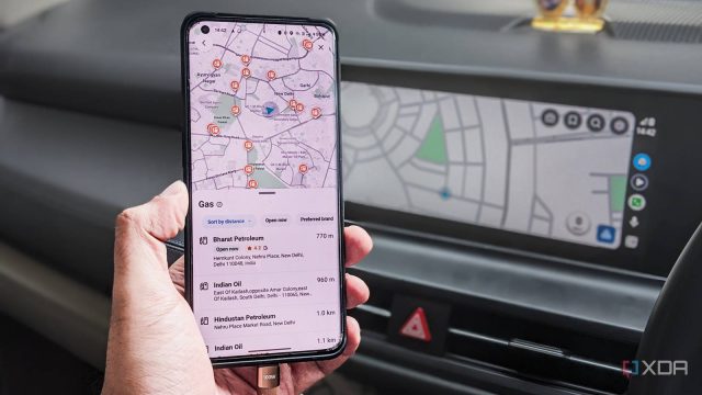 Google Maps on a phone in front of Android Auto