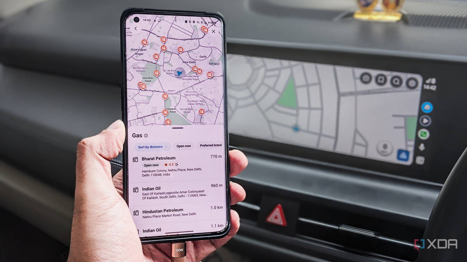 Google Maps on a phone in front of Android Auto