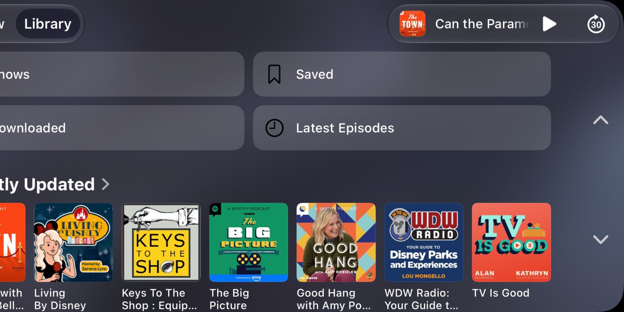 Màn hình CarPlay thư viện podcast với mini-player ở góc trên bên phải có ảnh bìa và nút phát