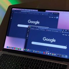 multiple windows of chrome displayed on macbook with blue light in the background