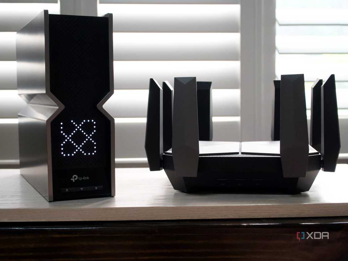 Photo of two routers - TP-Link Archer BE800 next to Archer AXE300
