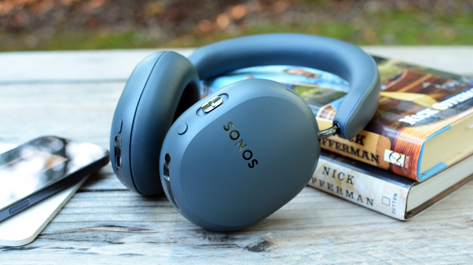Sonos Ace Ultra headphones laying on a stack of books.