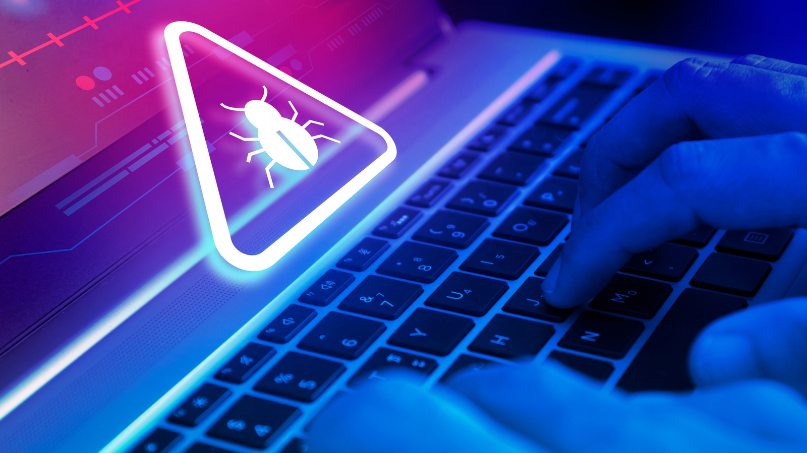 Bàn tay gõ phím trên laptop với biểu tượng cảnh báo mối đe doạ phía trên